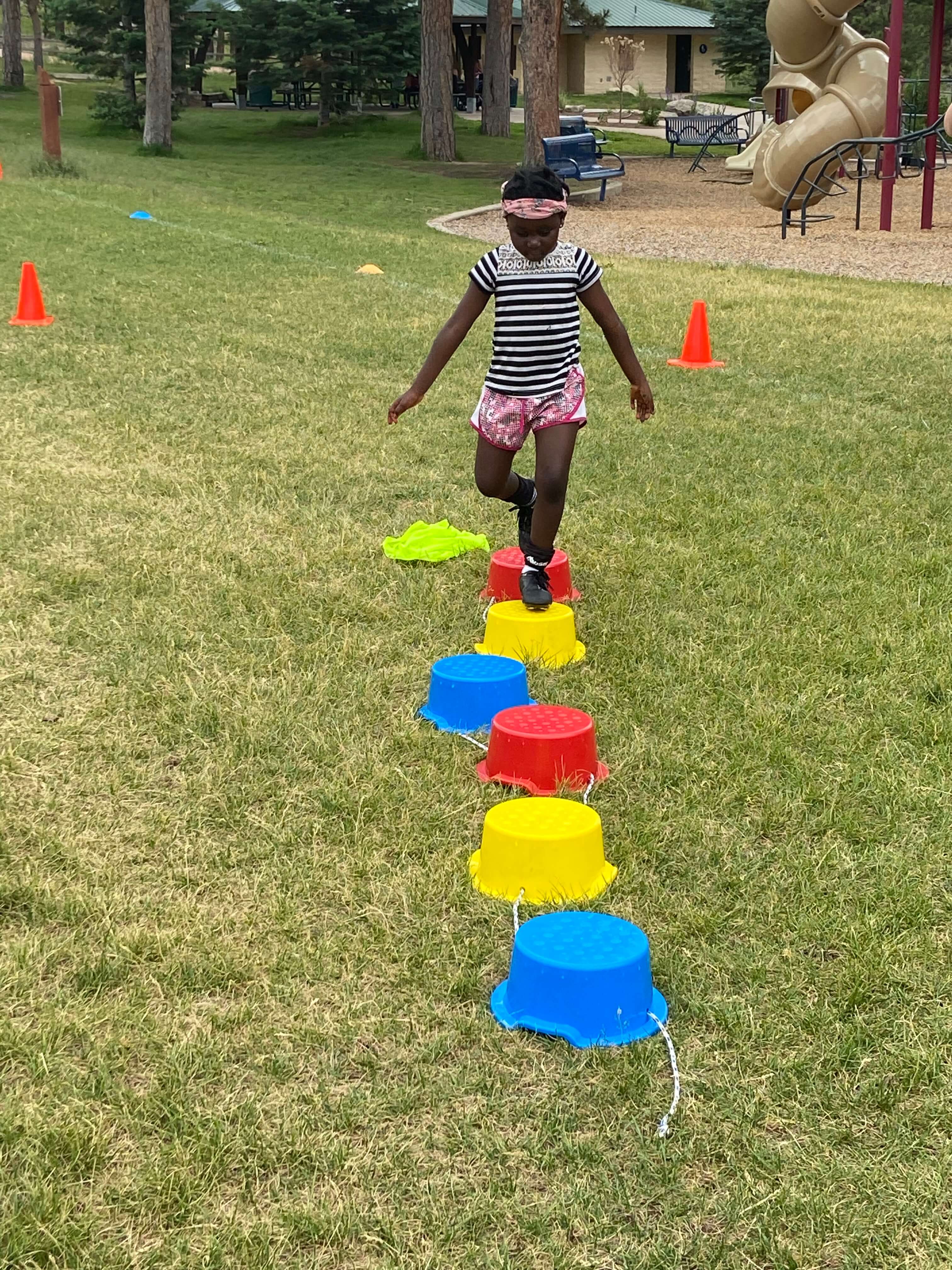 Child doing obstacle course at soccer camp